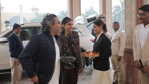 An image of few people standing at the entrance of Heritage Village Resorts & Spa where the annual celebration of golf is yet to begin