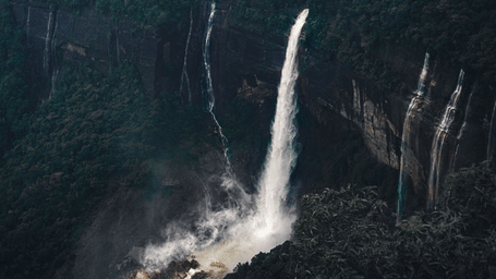A breathtaking view of kynrem waterfalls cascading in the lush forests of Shillong,