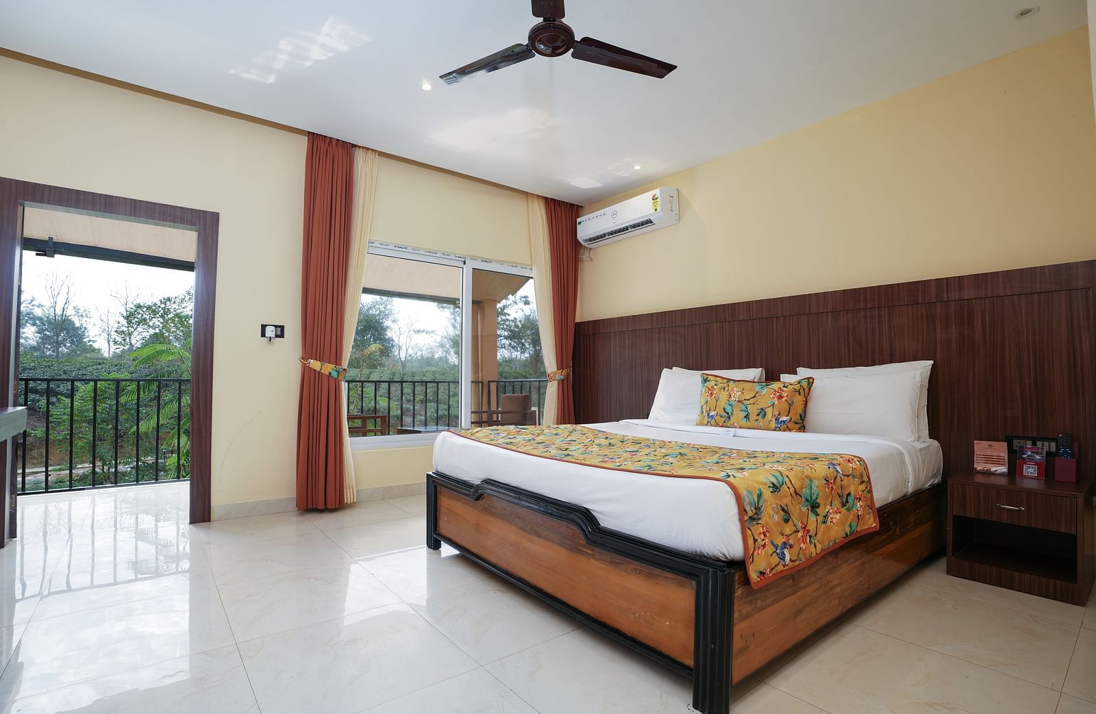 Premium room with balcony offering a nature view and spacious bed at Summit Green Lake Tea Resort & Spa, Kaziranga