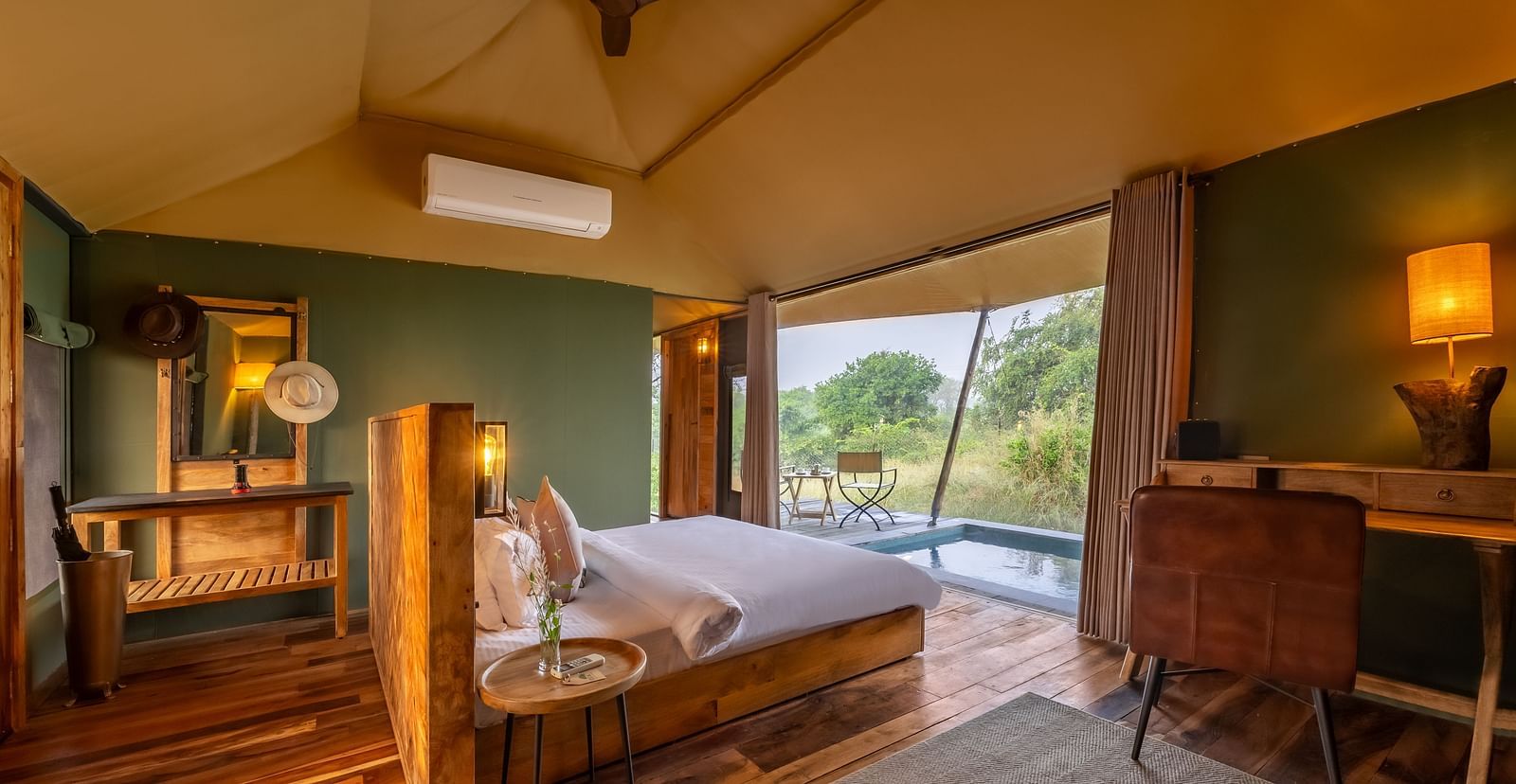 An interior of a room with double bed at Trees N Tigers, Tadoba.