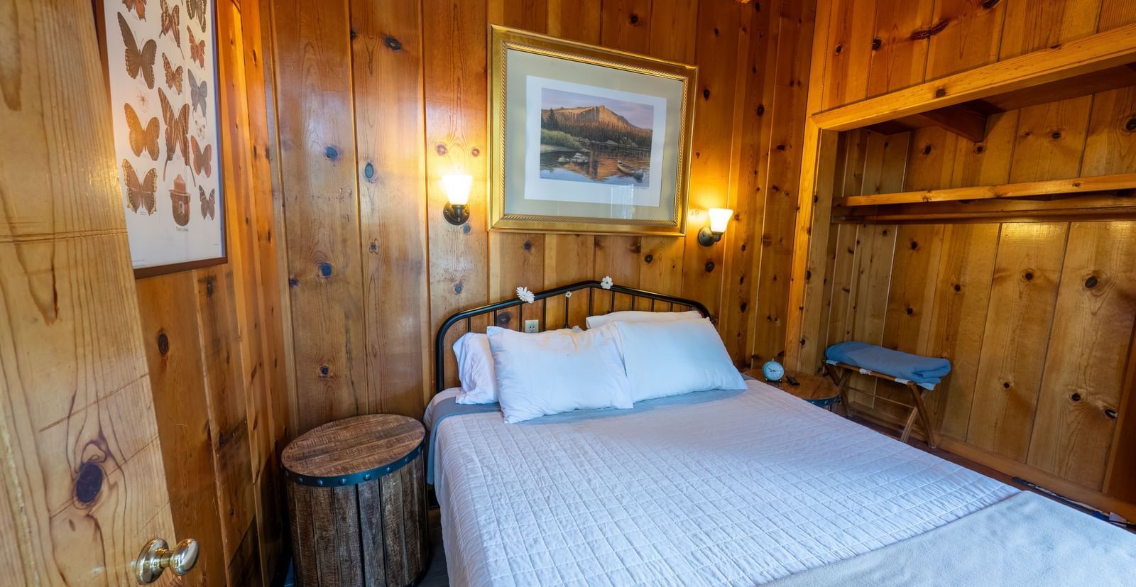 Cozy bedroom with queen bed and warm lighting at Kit Carson Lodge.
