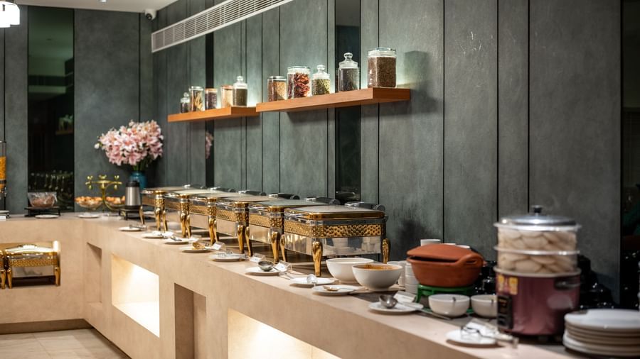 Buffet spread with assorted jars and traditional pots at Hotel Royal Regency Chennai