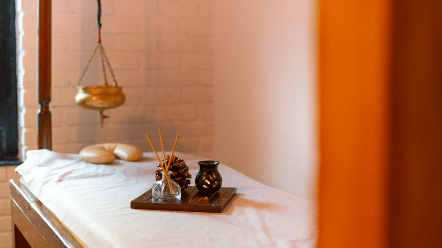 A specialised Ayurvedic therapy room featuring a traditional wooden Shirodhara setup - Johnson Lodge & Spa, Manali