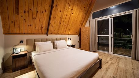An image of a room with king size bed, bed side tables, cupboard - Trance Veechika Resort, Vikarabad
