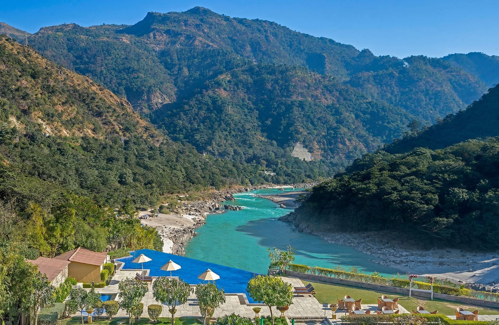 An image capturing a breathtaking landscape featuring a serene river winding through a mountainous valley.