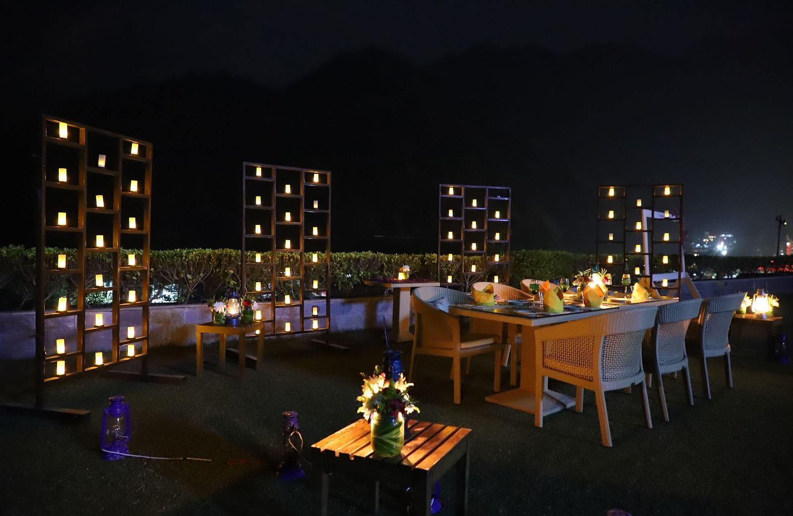 An image showing chairs and tables arranged on the calm dim lit outdoors - The Naini Retreat, Nainital