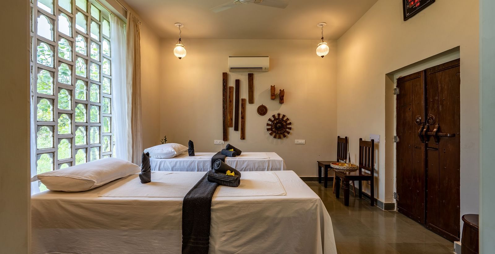 A side angle of the spa with ambient lighting and two beds - Utsav Camp