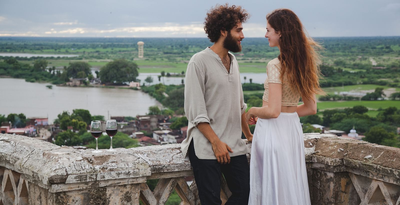 A couple posing for a picture and waterbodies behind them- Shahpura Bagh.