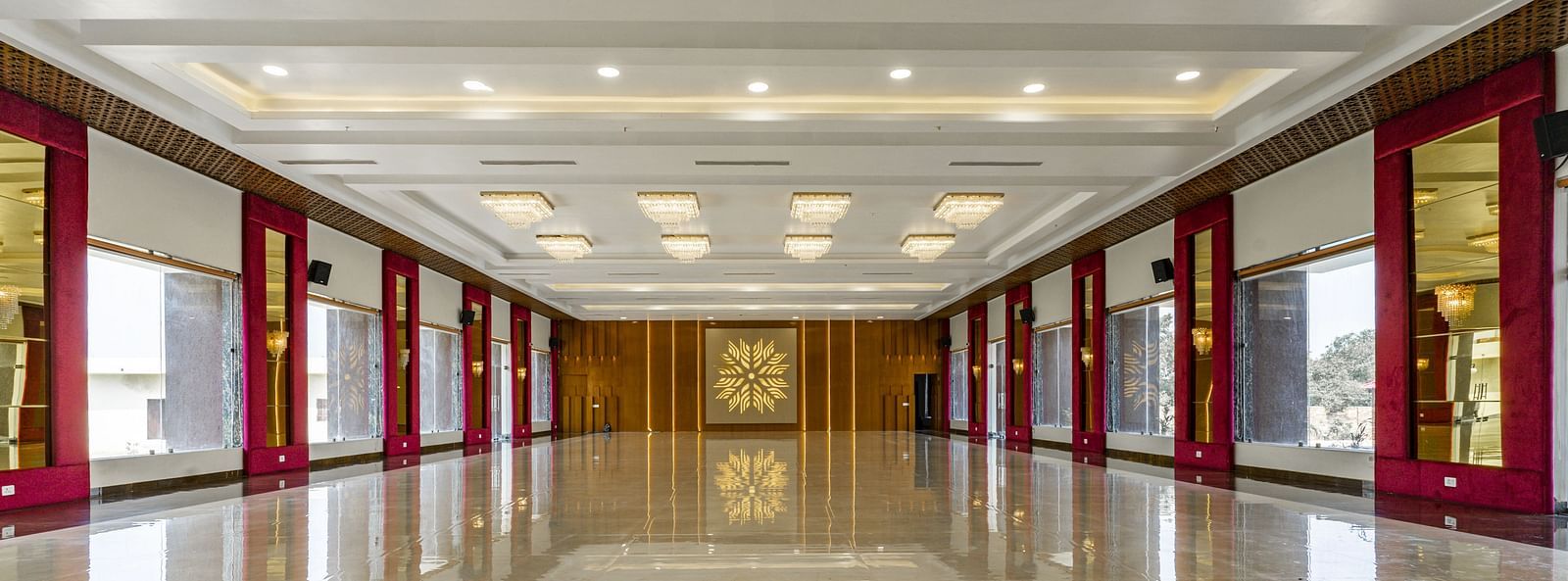 A long, empty hallway with a highly polished floor that reflects the ceiling and walls - Bamboo Saa Mulberry Resort, Pushkar