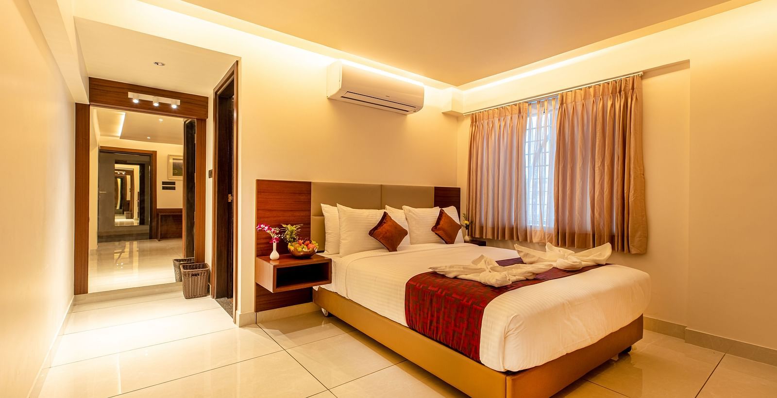 An image of a room with a bed and an open door on the side at M Pro Palace.