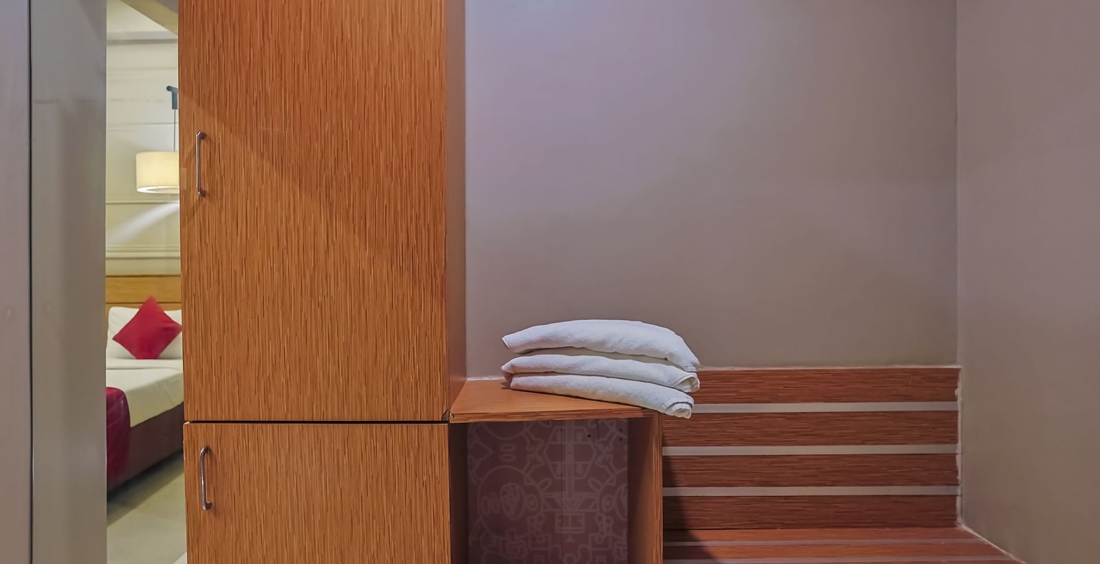 Closet with towels and storage shelves at Max Hotel Prayagraj.