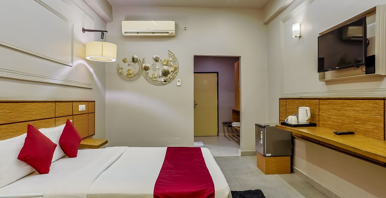Tidy room with side table and modern amenities at Max Hotel Prayagraj.