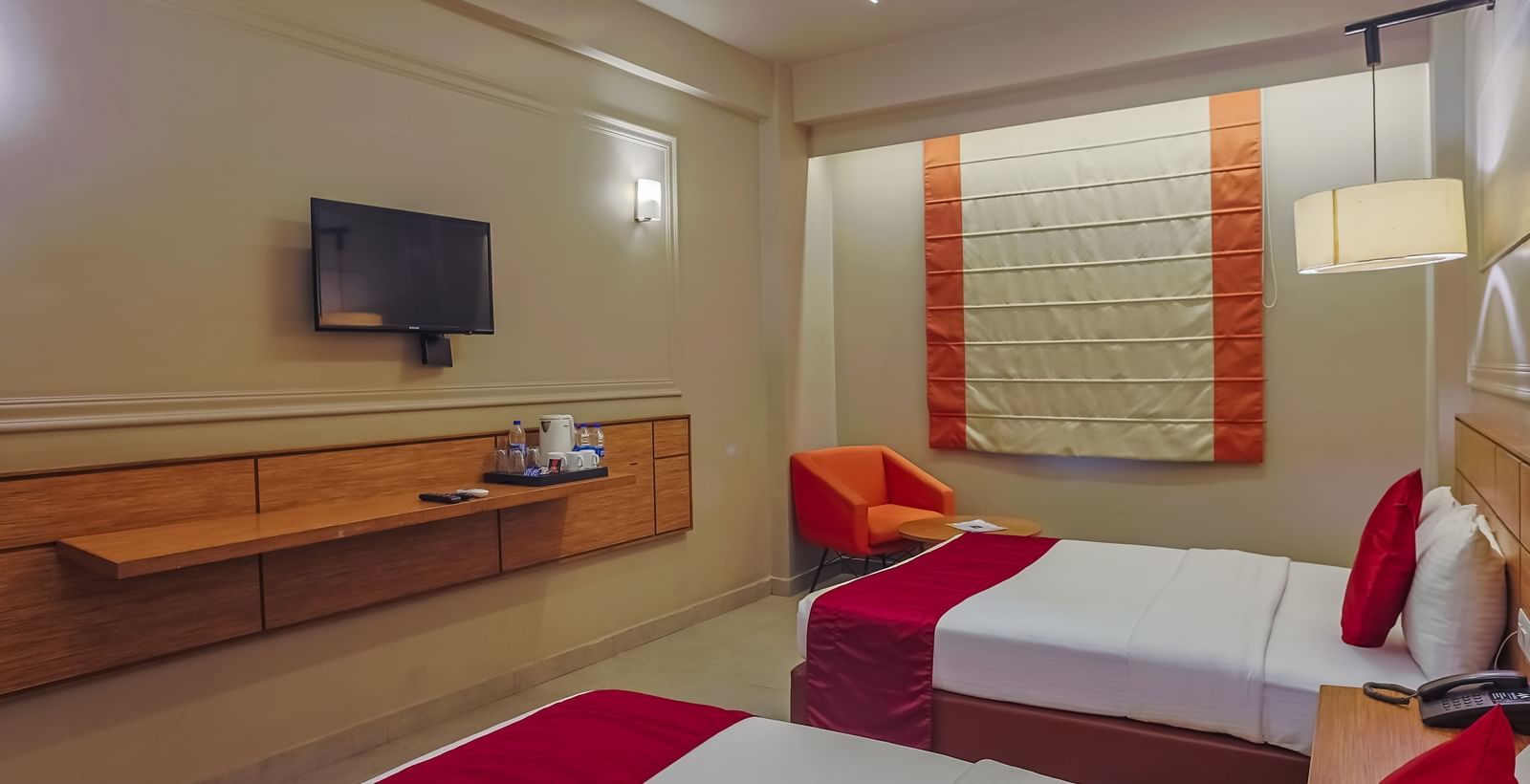 Bedroom with sitting area and natural light at Max Hotel Prayagraj.