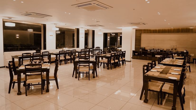 Pride Ranakpur Resort Convention Centre - interior view of the property restaurant featuring numerous tables and chairs