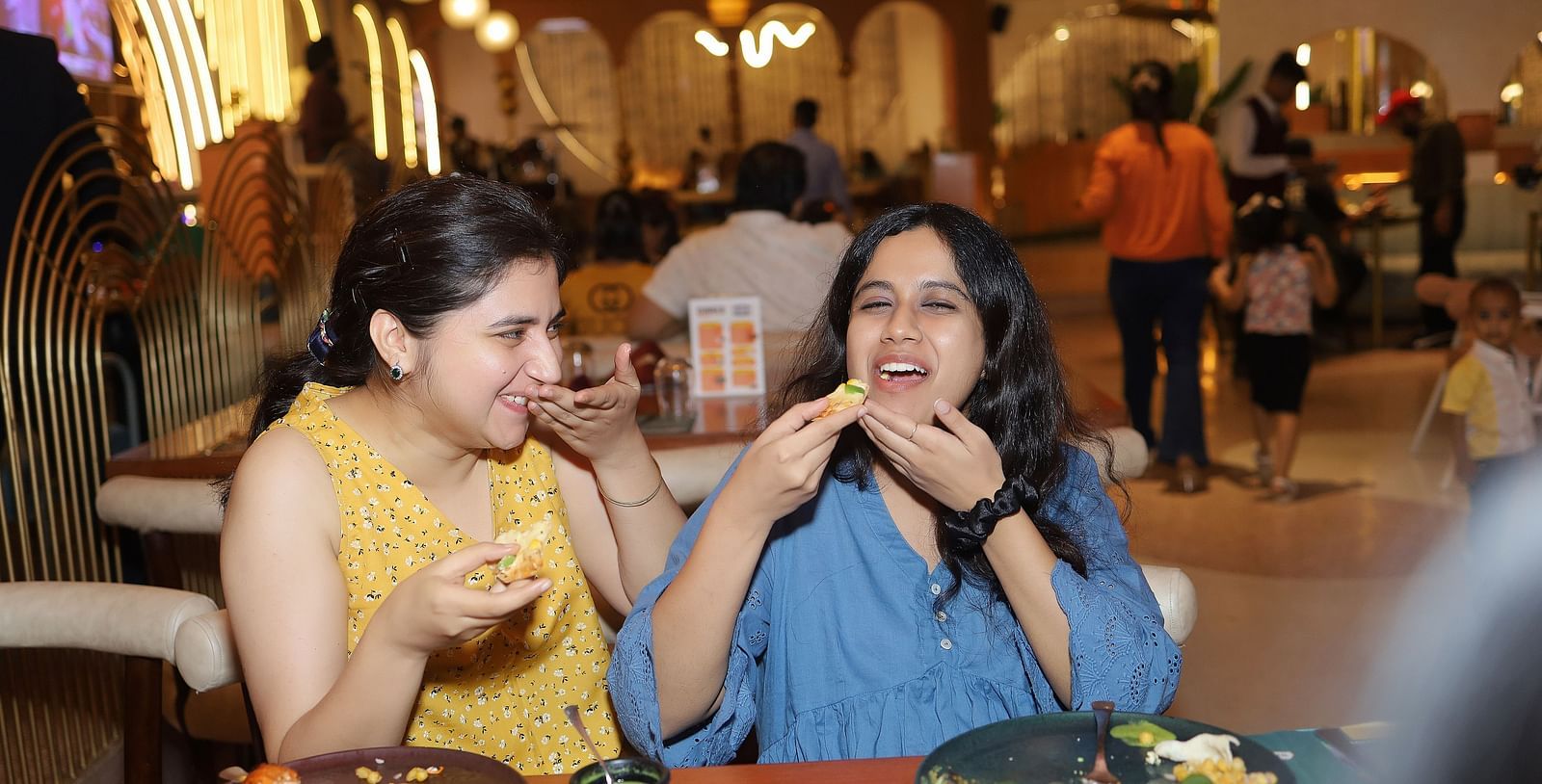 An image of two women eating at a barbecue house in Themis Barbecue House, Ambala
