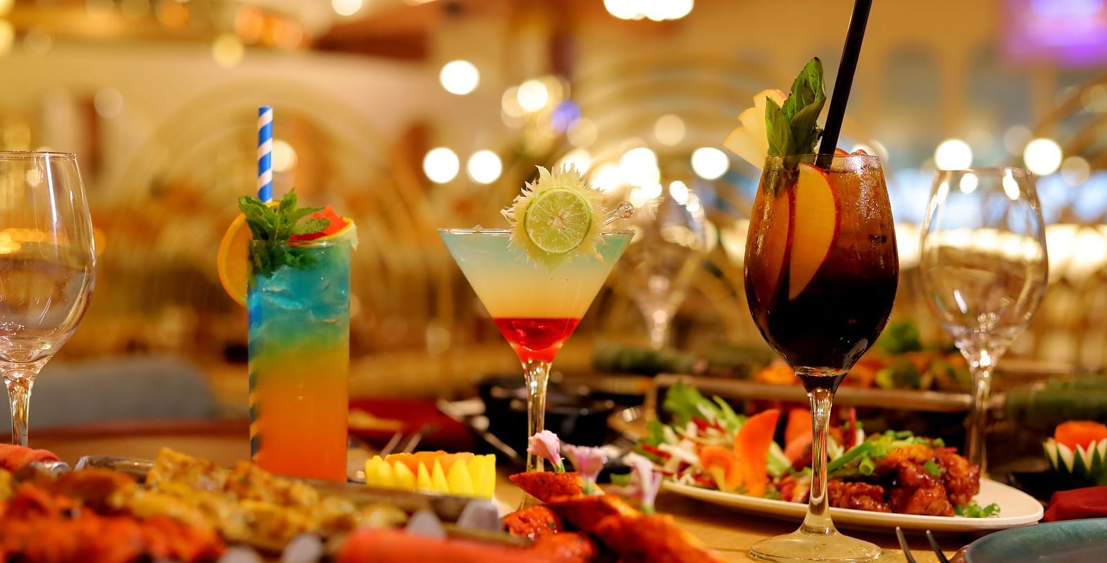 An image of a table where barbecue grilled dishes are kept along with fancy beverages at Themis Barbecue House, Amabala