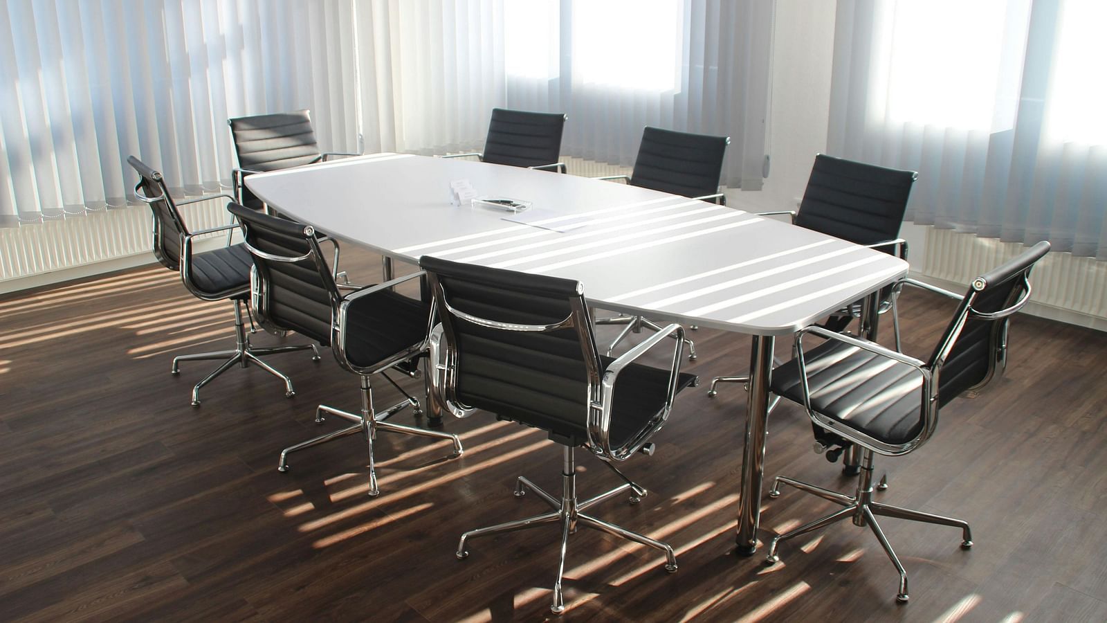 An image of a boardroom with chairs and a table