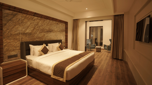 Superior room with king size bed and other amenities at Classic Sapphire by Ananta