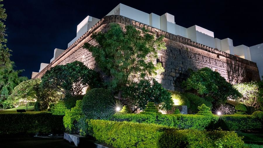 Magnificent building of Fort Jadhavgadh Heritage hotel with garden in Pune