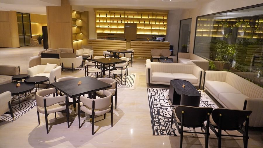 Relaxing hotel lounge area furnished with comfortable sofas, stylish armchairs, and small tables, situated by large windows that bring in ample daylight - The Orchid Hotel, Chandigarh