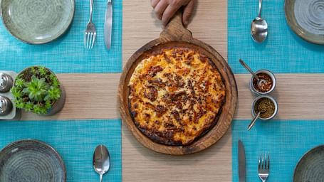 A fresh pizza served hot with toppings at BluSalzz Escapade Resort, Lansdowne.