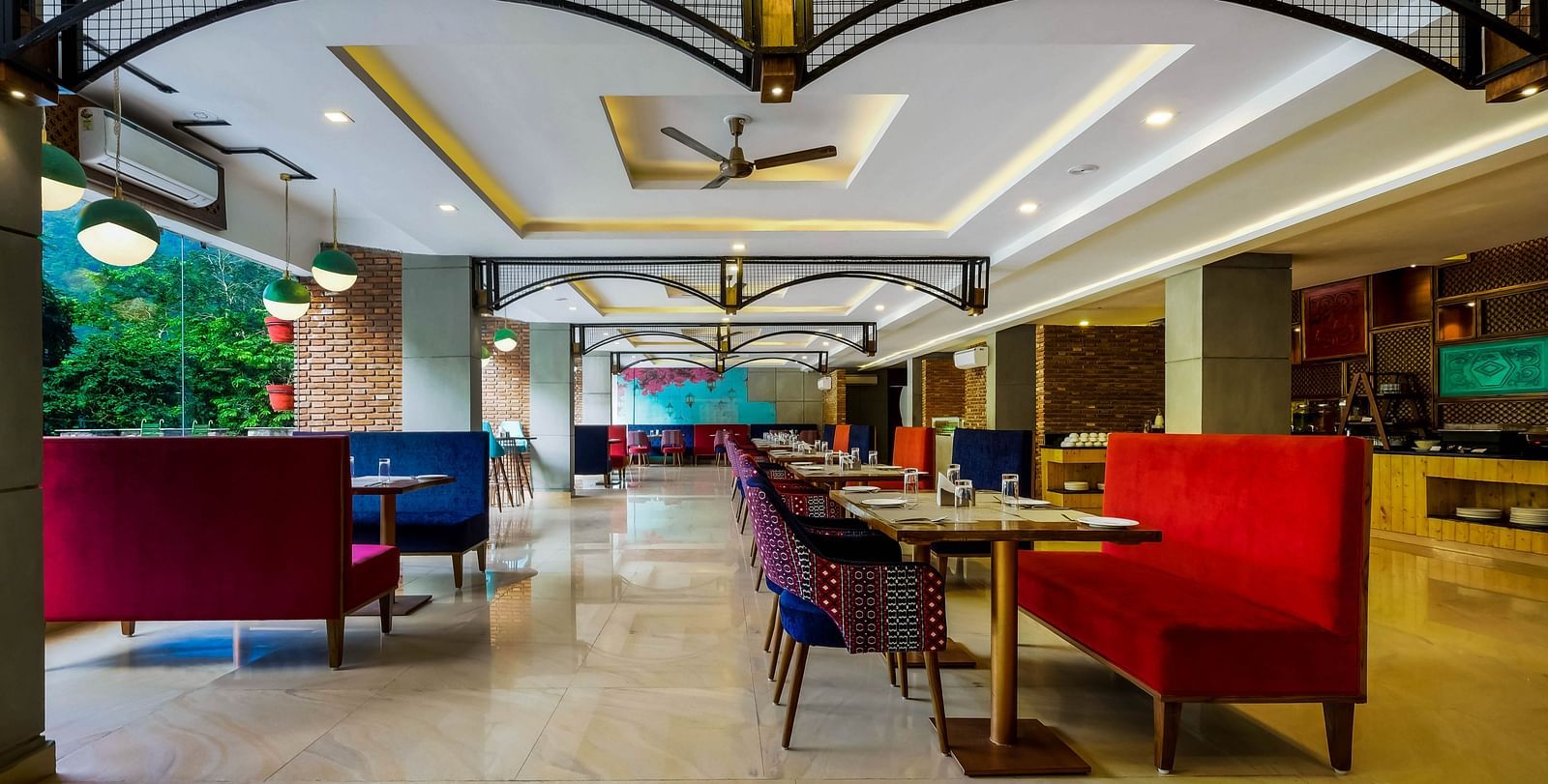 Image of a dining area with sofas and tables at Summit By The Ganges Beach Resort & Spa, Rishikesh