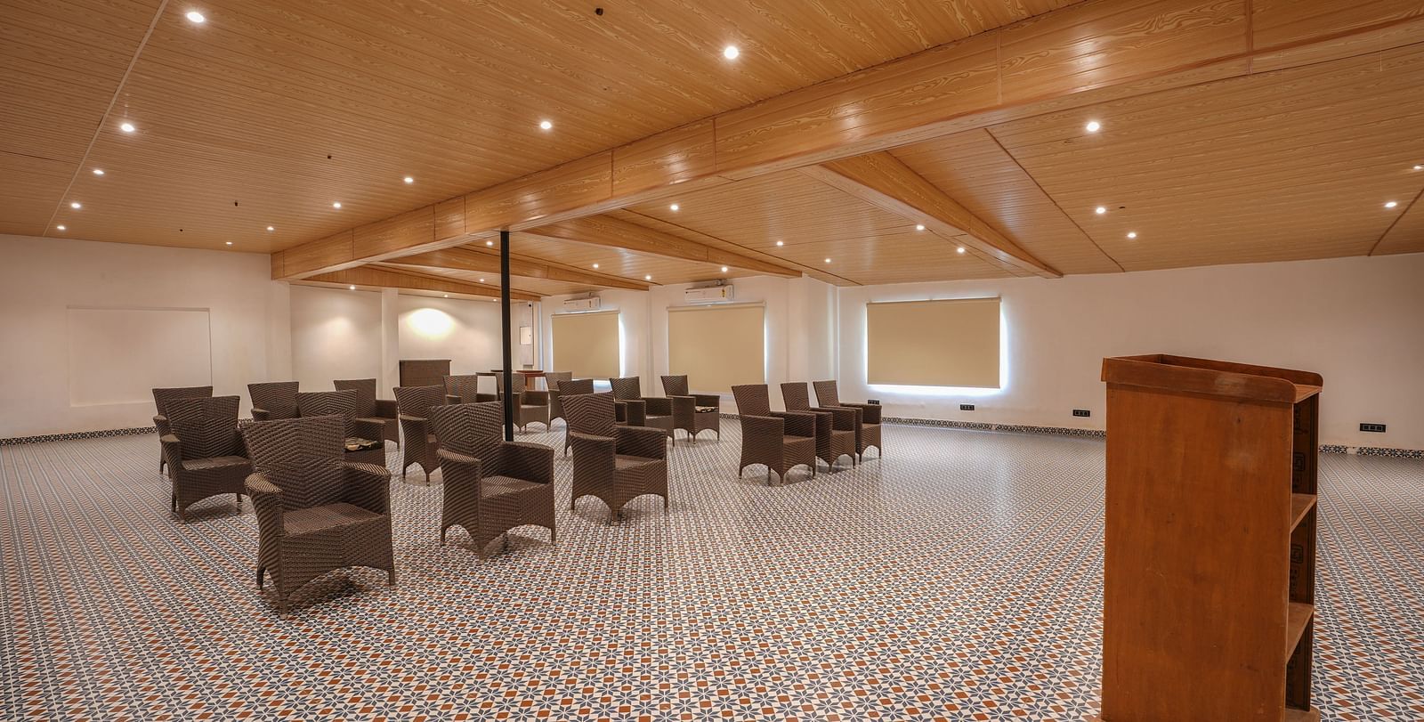 An image of a expansive banquet hall with a podium and seating arrangement.