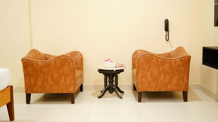 an image featuring two sofa chairs and a table - A M Suites
