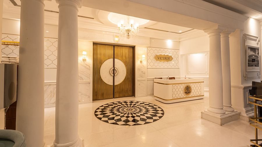 Image featuring the Viceroy Hall event venue at The Claridges New Delhi, showcasing the doorway, reception in the corner, and an elegant chandelier hanging