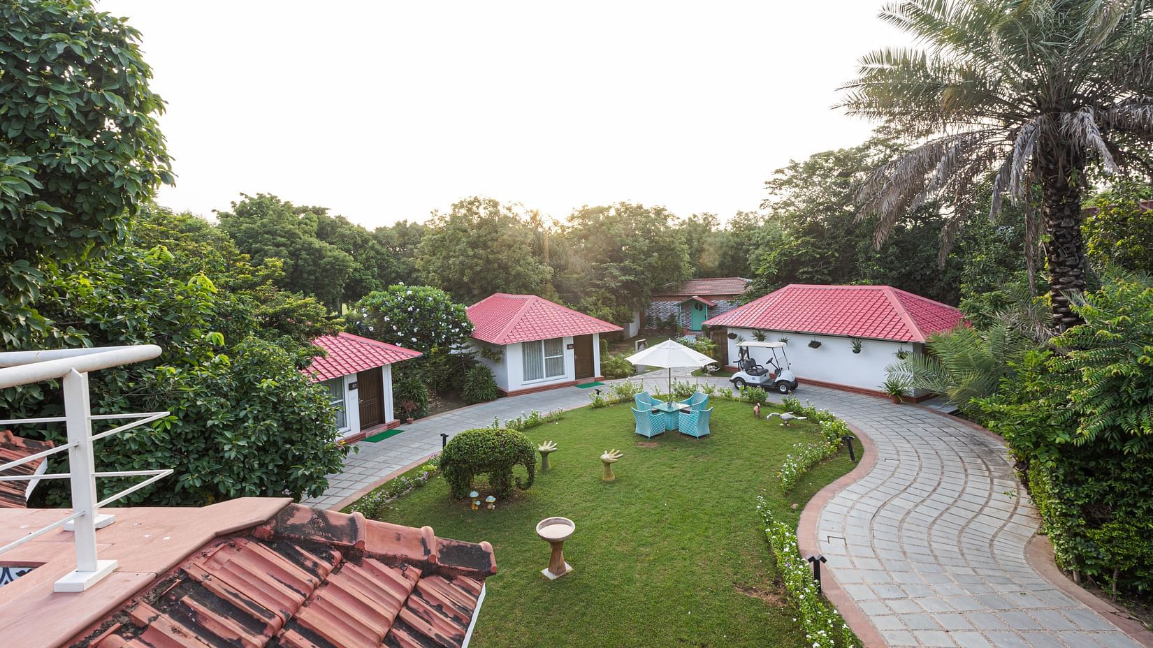 An top view of Karma Cottages with a garden and chairs in view - Karma Lakelands.