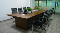 A boardroom set up with a wooden desk and chairs.