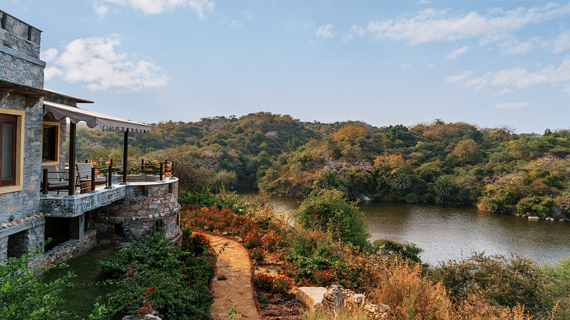 A view of the lake, forest and the accommodation at Chunda Shikar Oudi, Udaipur