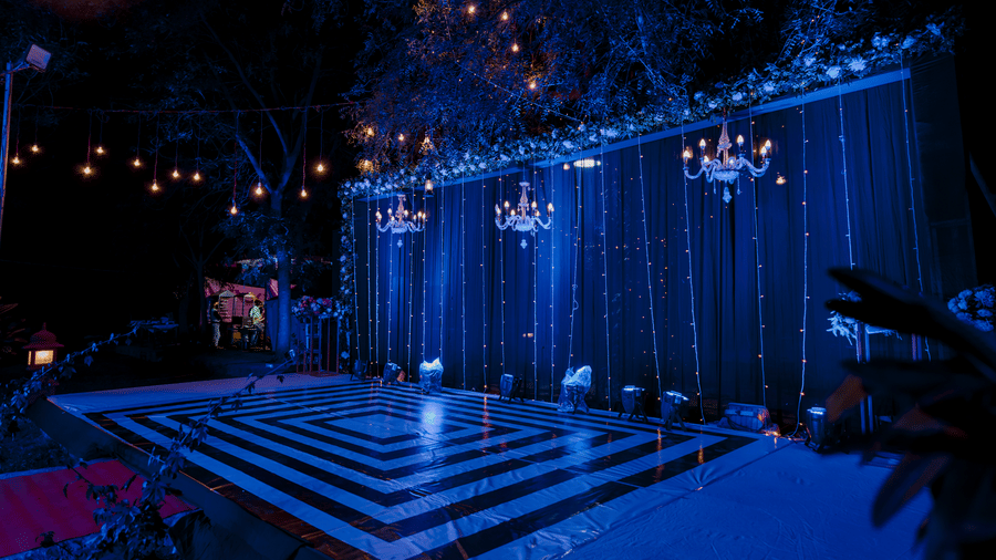 Elegant wedding stage setup with ambient lighting for evening celebrations.