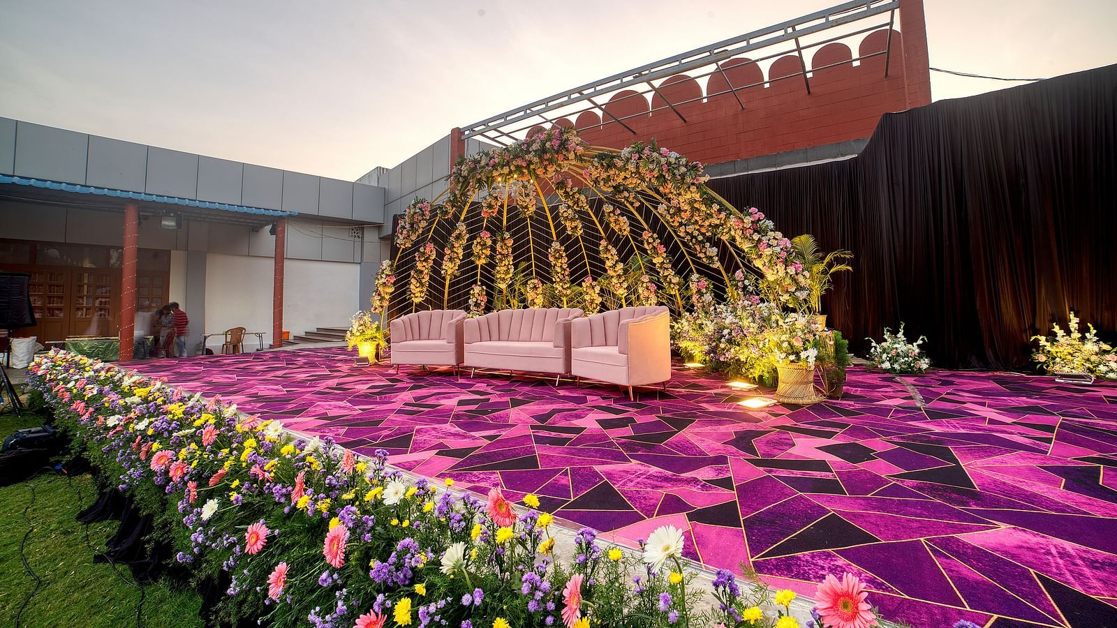 Floral-themed outdoor stage setup ideal for weddings and ceremonies at Kailash Conventions ECR.