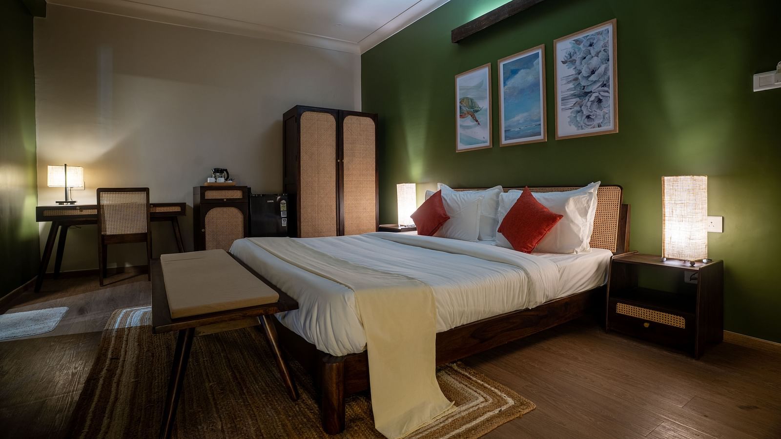 Well-lit bedroom with green accent wall, cosy furnishings, and twin beds at Kssemya.
