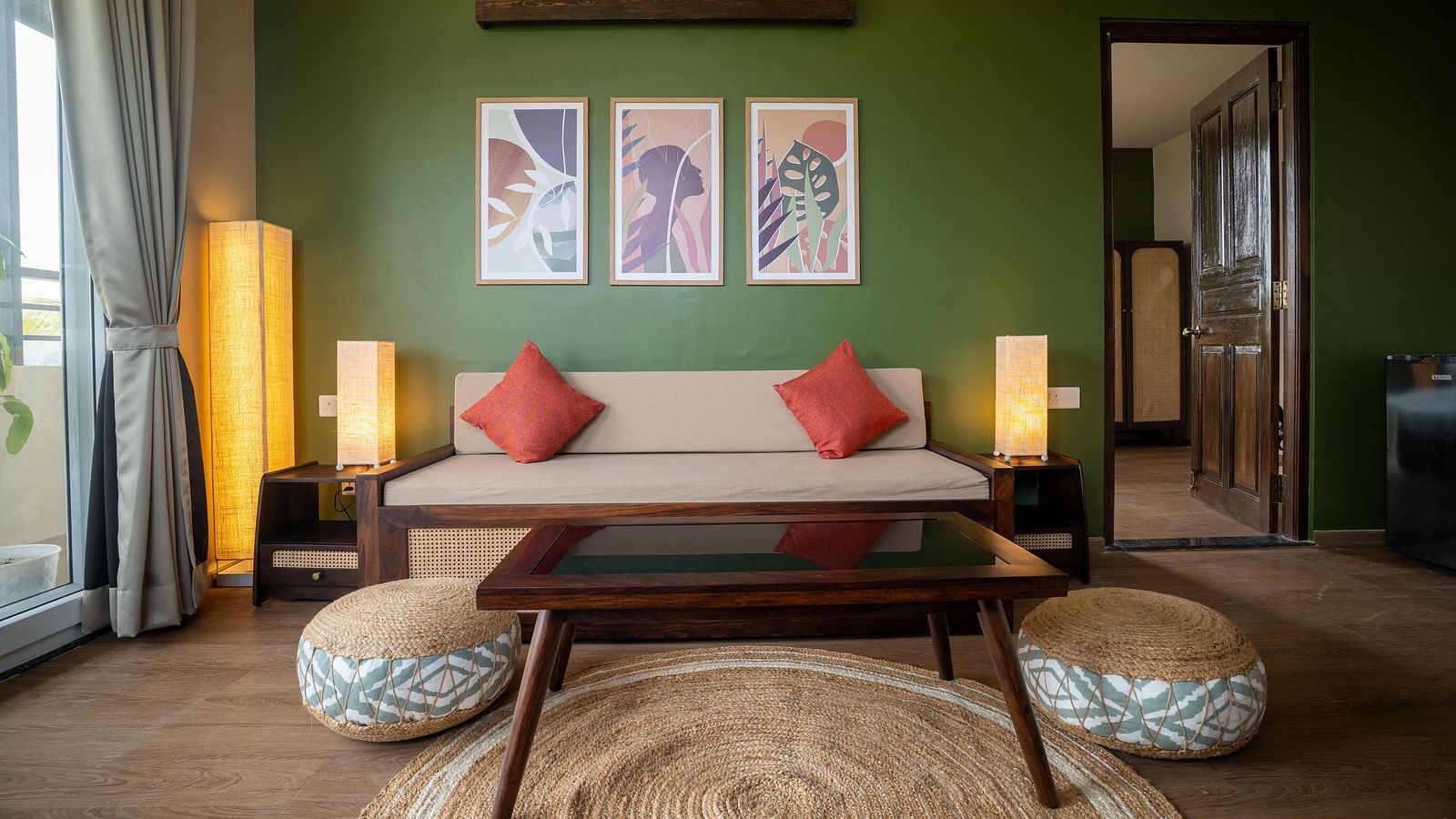 Chic living area with a wooden coffee table, pouffes, and contemporary wall art at Kssemya.