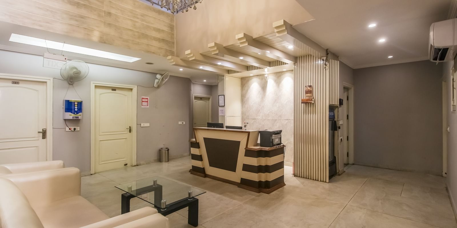 Reception and lobby lounge area with sofas at Hotel Diamond Plaza, Chandigarh