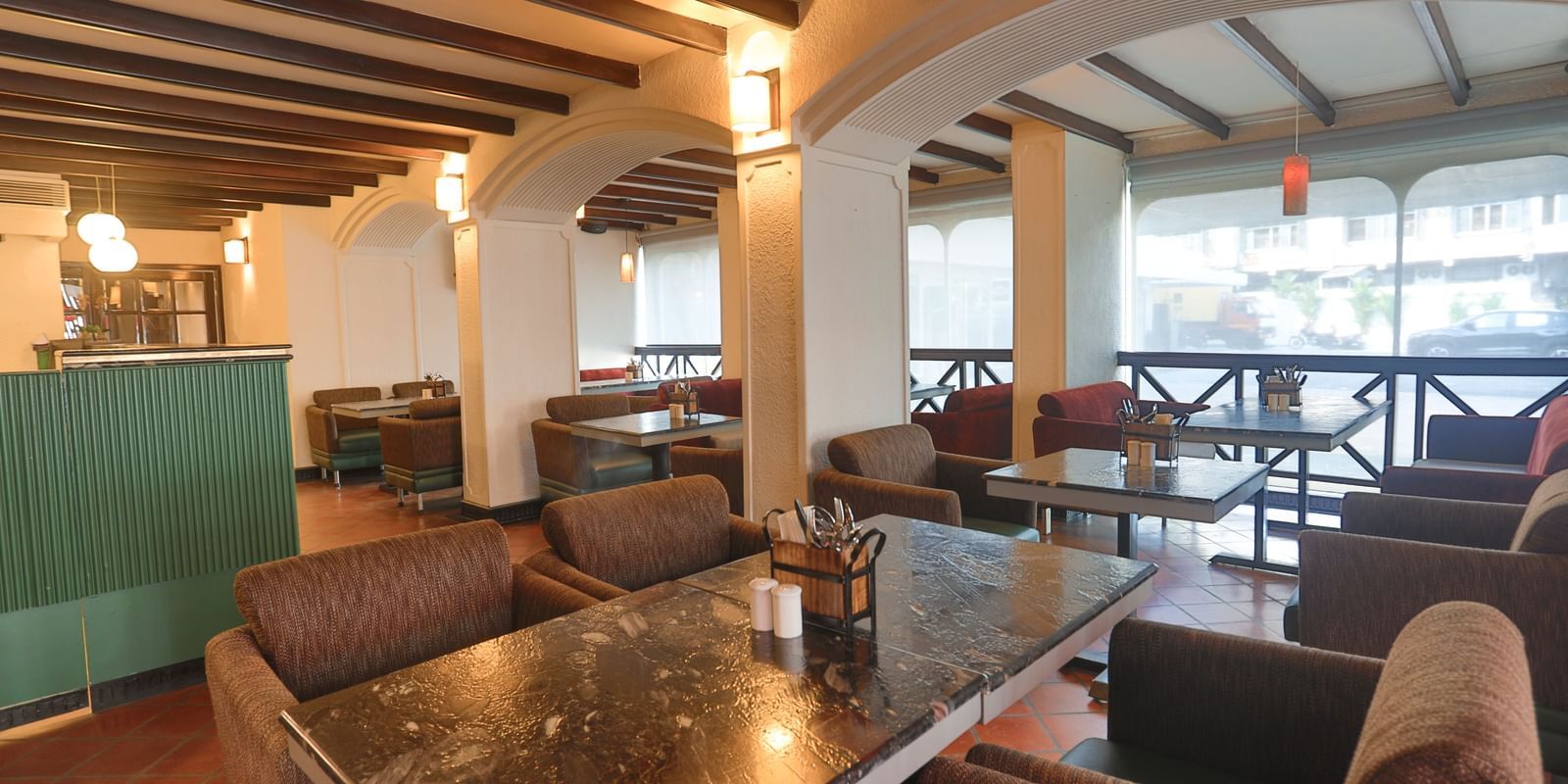 A restaurant interior with wooden beams and various seating arrangements | Shilton Hotels