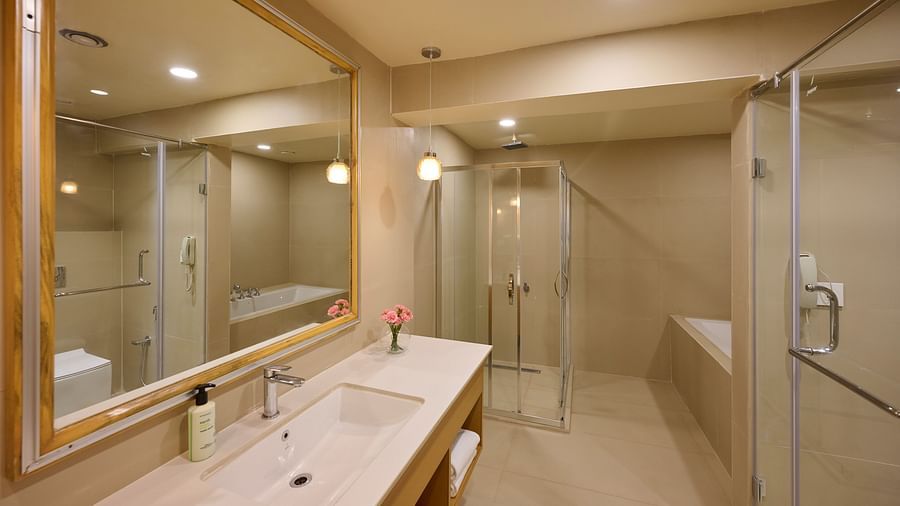 wash basin and shower area in the bathroom of the Cottage at ABN Sarovar Portico, Jim Corbett