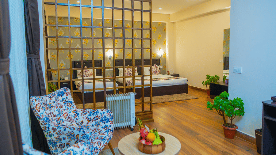 Dream Villa Retreat, Pelling - The interiors of the Suite in our hotel with a colourful lounge chair kept in the living area