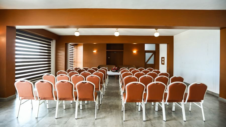 brown and white chairs placed in the banquet hall of La Montana By TGI, Ooty