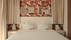 Elegant bedroom with red accent wallpaper and twin mirrors at Three BHK Premium Villa, Richmonde Ananta Elite, Goa.