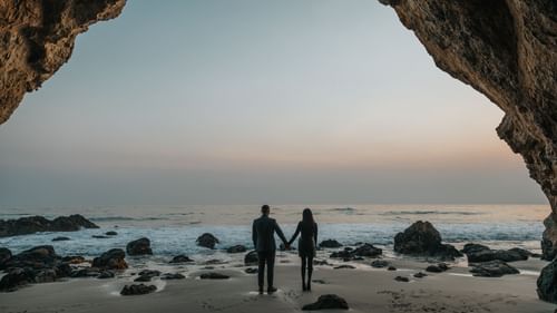 a couple holding hands at a beach