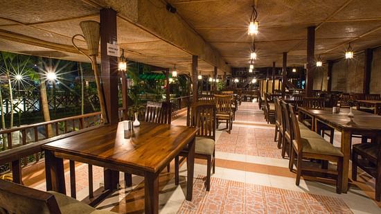 An image of the restaurant with its seating arrangement and minimal decoration - Symphony Palms Beach Resort & Spa