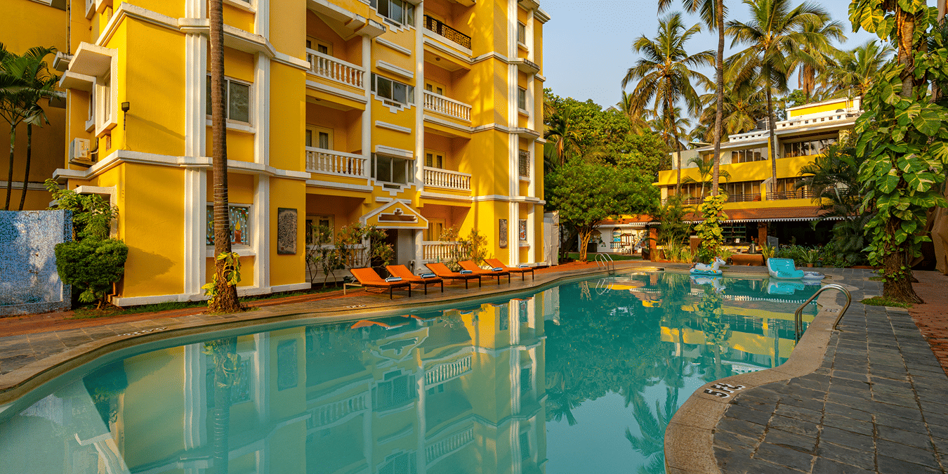 The pool of the hotel surrounded by the hotel building.