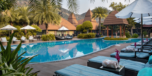 Lounge chairs set beside the pool at our 5-star resort in Pushkar 