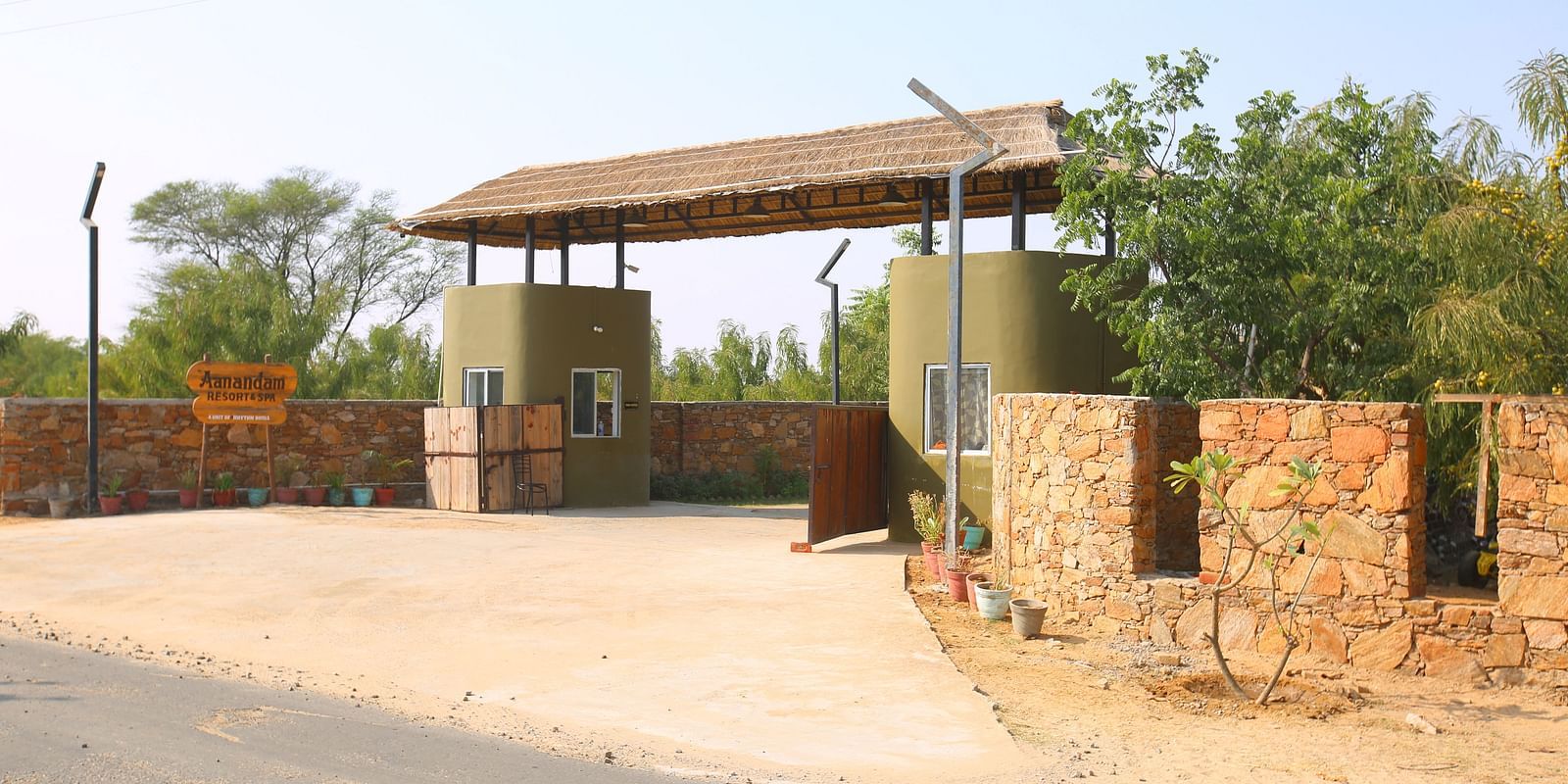 Exterior view of the hotel's entryway at Aanandam Resort & Spa, surrounded by trees