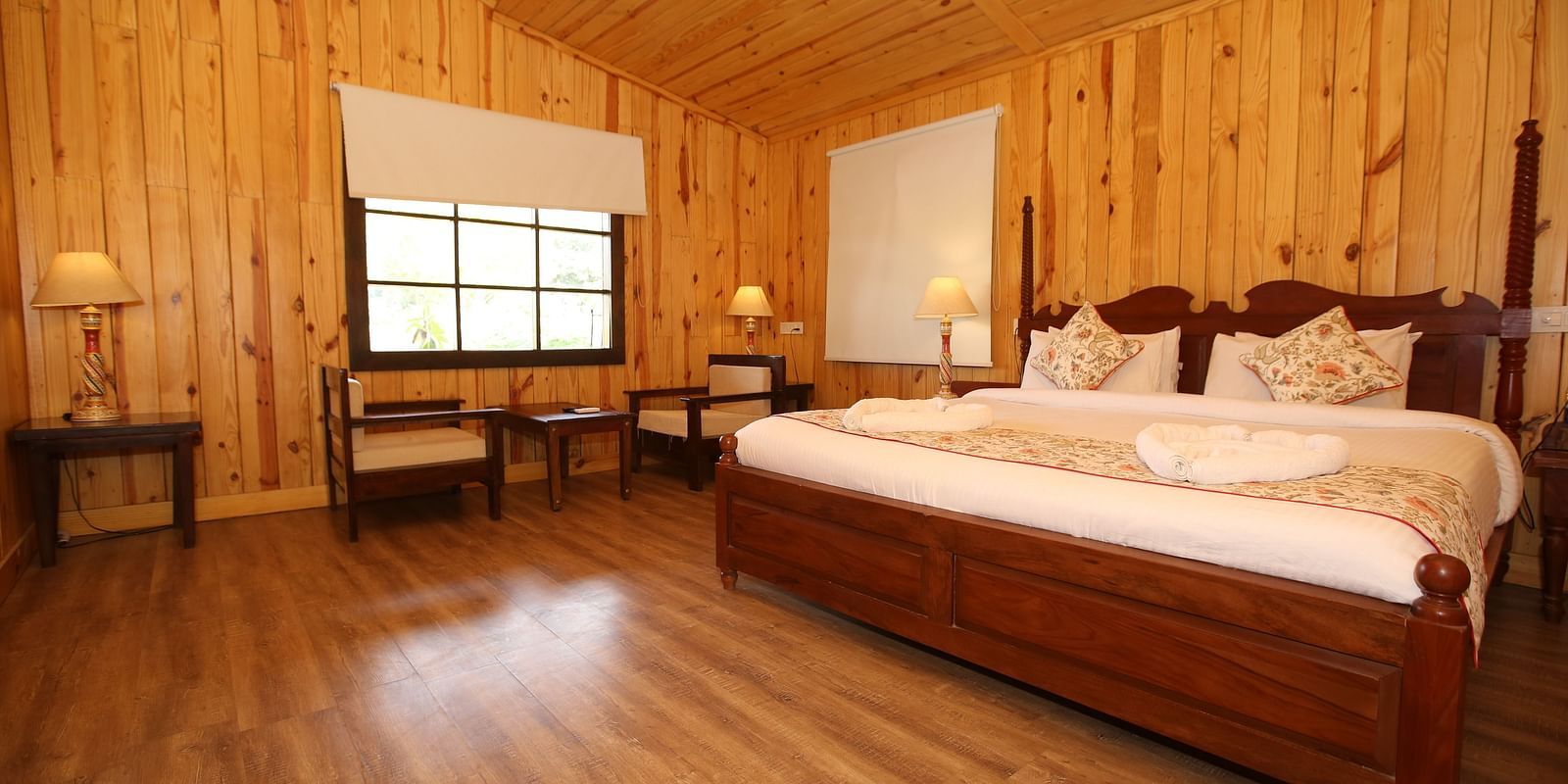 Spacious Kashmir Cottage Villa's Pool room with a king-sized bed, wooden flooring at Aanandam Resort & Spa