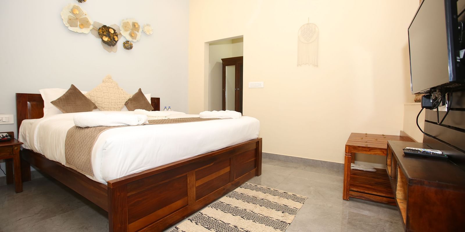 Studio Villa room with a spacious king-sized bed and a wall-mounted TV at Aanandam Resort & Spa