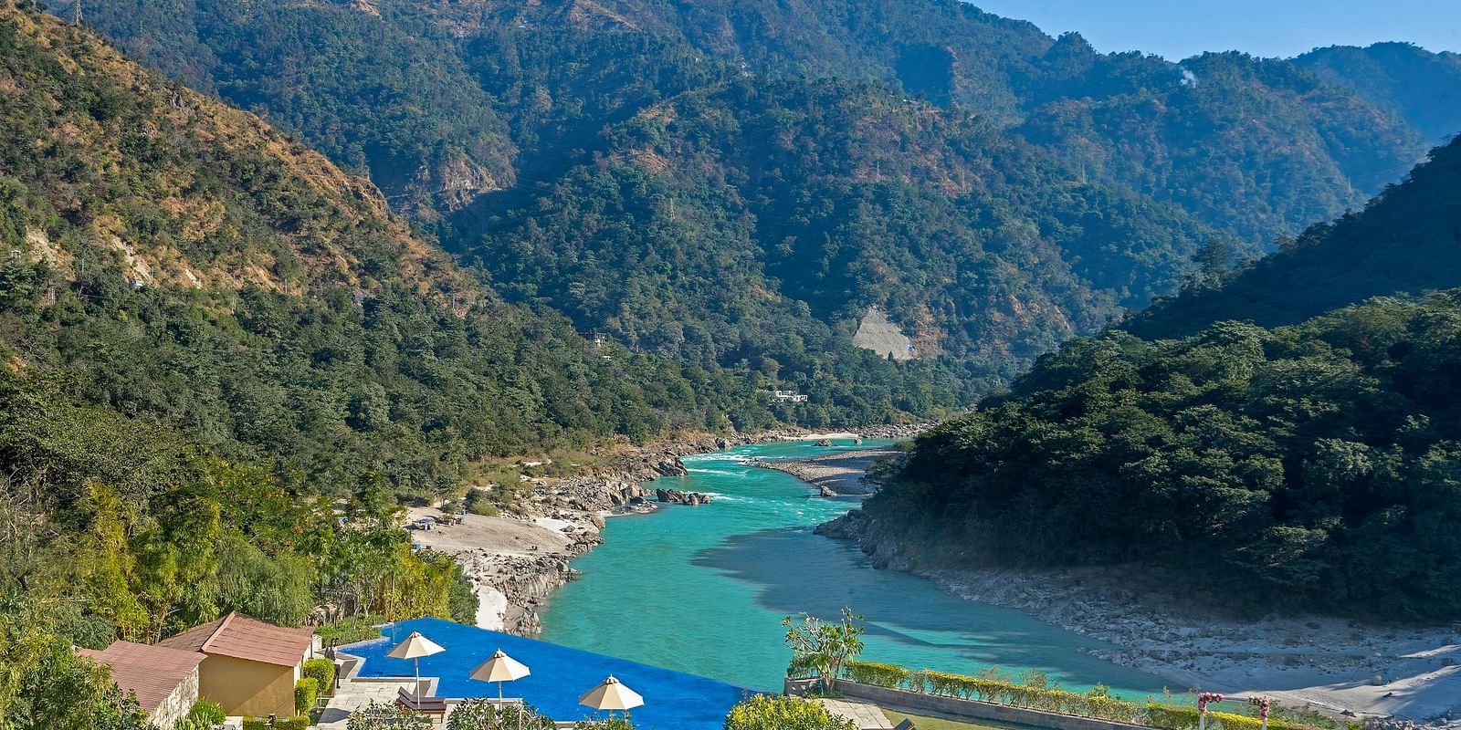 An image capturing a breathtaking landscape featuring a serene river winding through a mountainous valley.